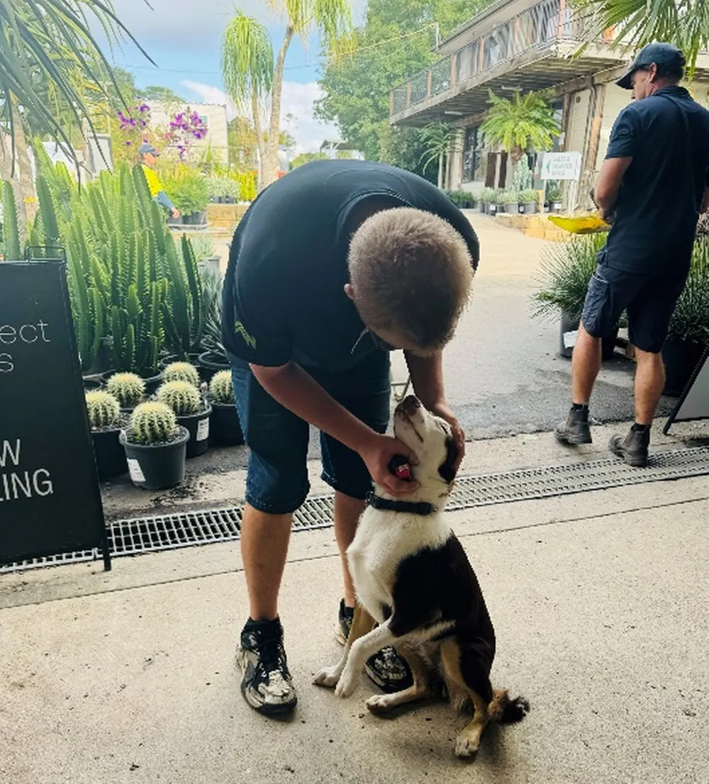 man petting his dog